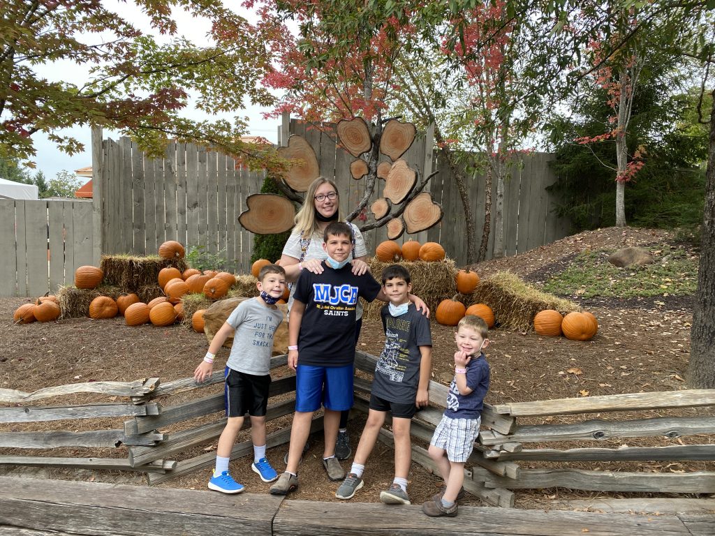 the author and her family in front of a pumpkin display