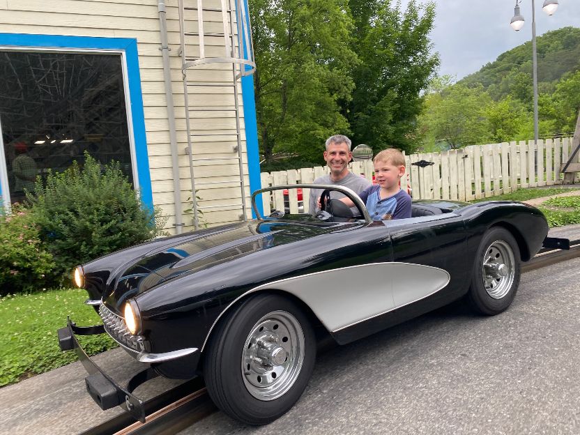 the author's husband and youngest son on the rockin roadway ride at dollywood