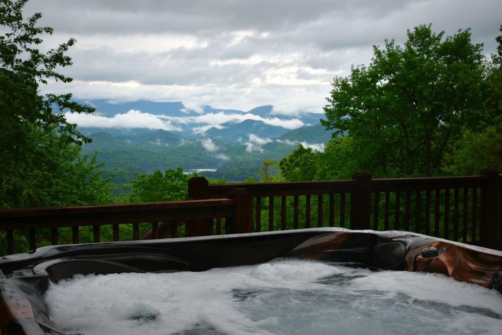 cabin hot tub with view of smoky mountains