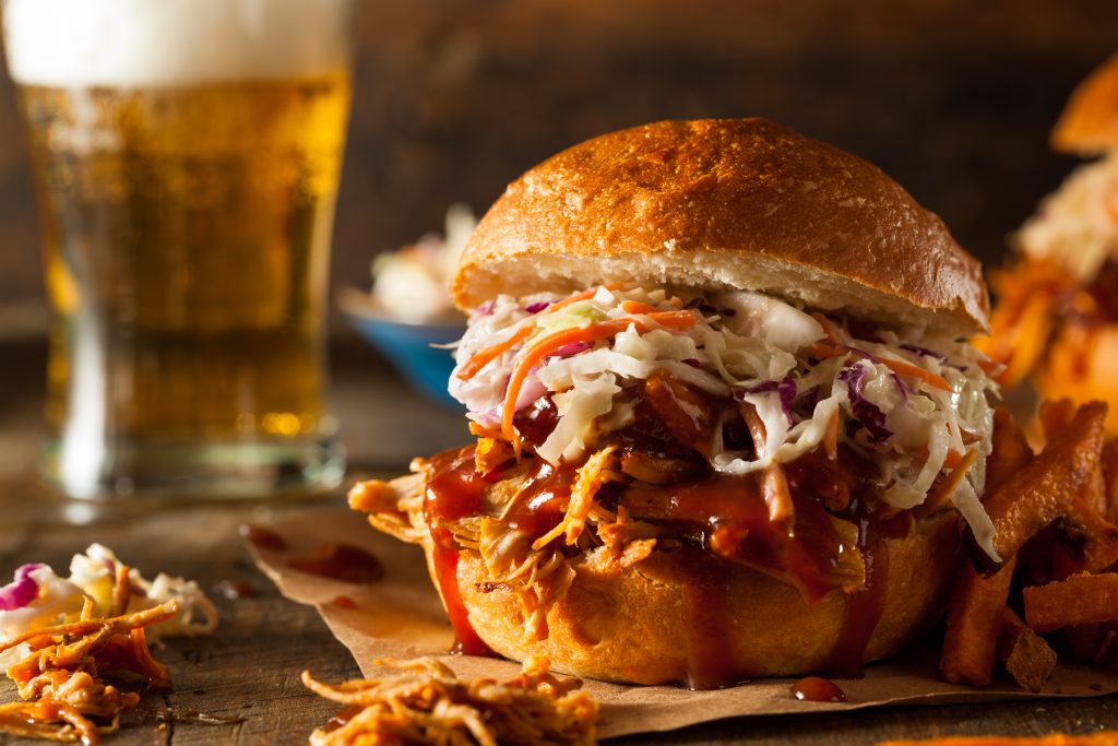 best bbq in gatlinburg on a sandwich with a craft beer in the background