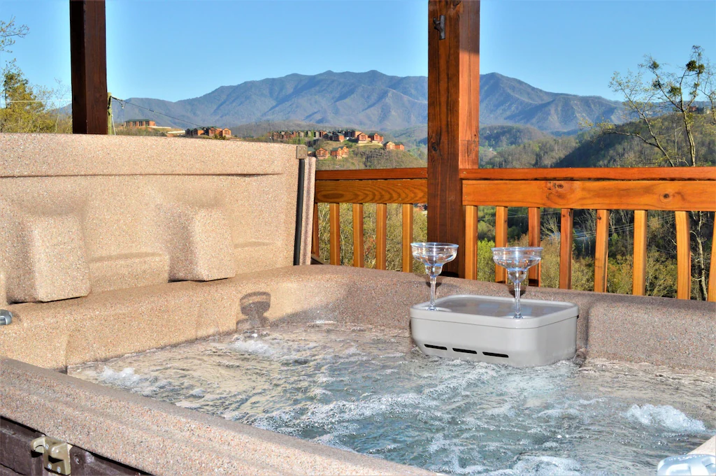 hot tub on covered deck with view of the smokies
