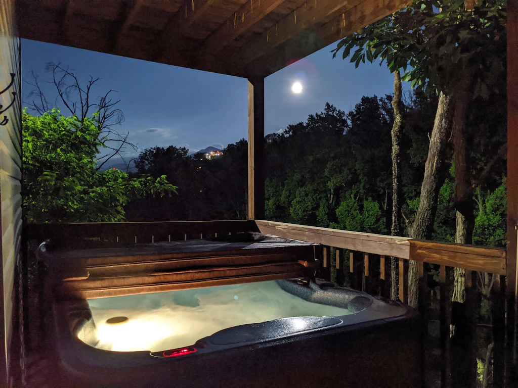 outdoor hot tub on deck at night