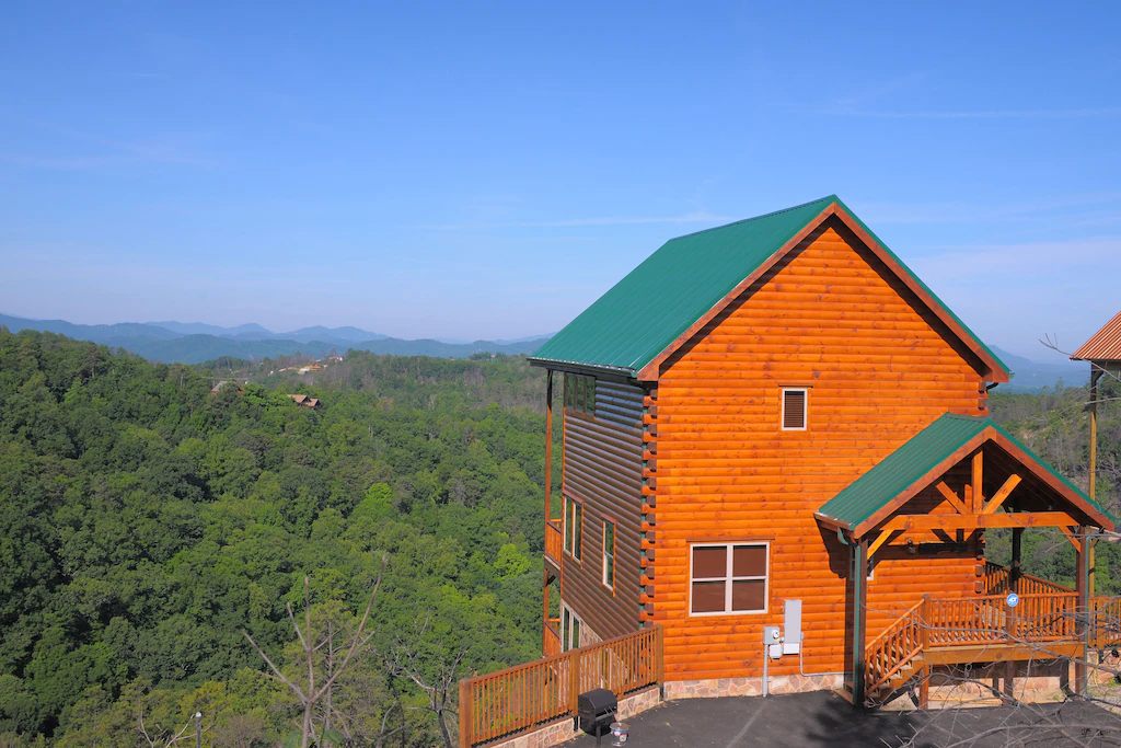 view of cabin perched on mountainside with view of the smoky mountains