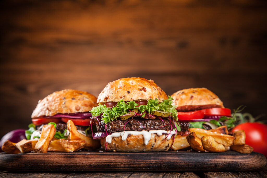 Close-up of home made burgers on wooden background