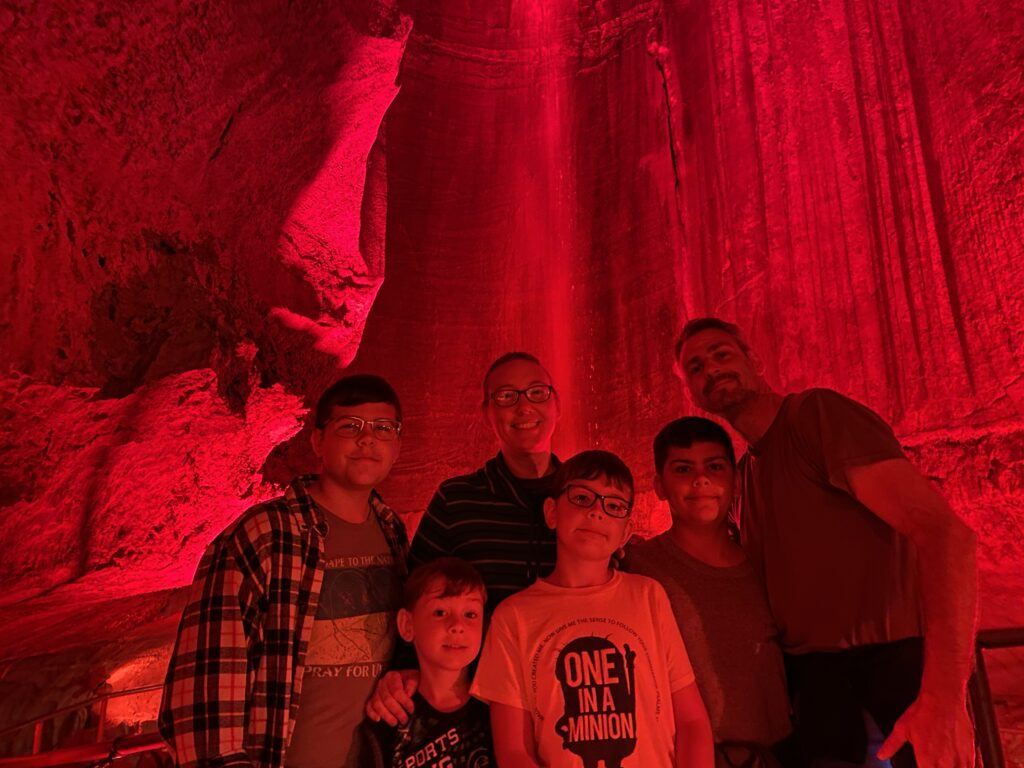 the author and her family in front of Ruby Falls during the light show