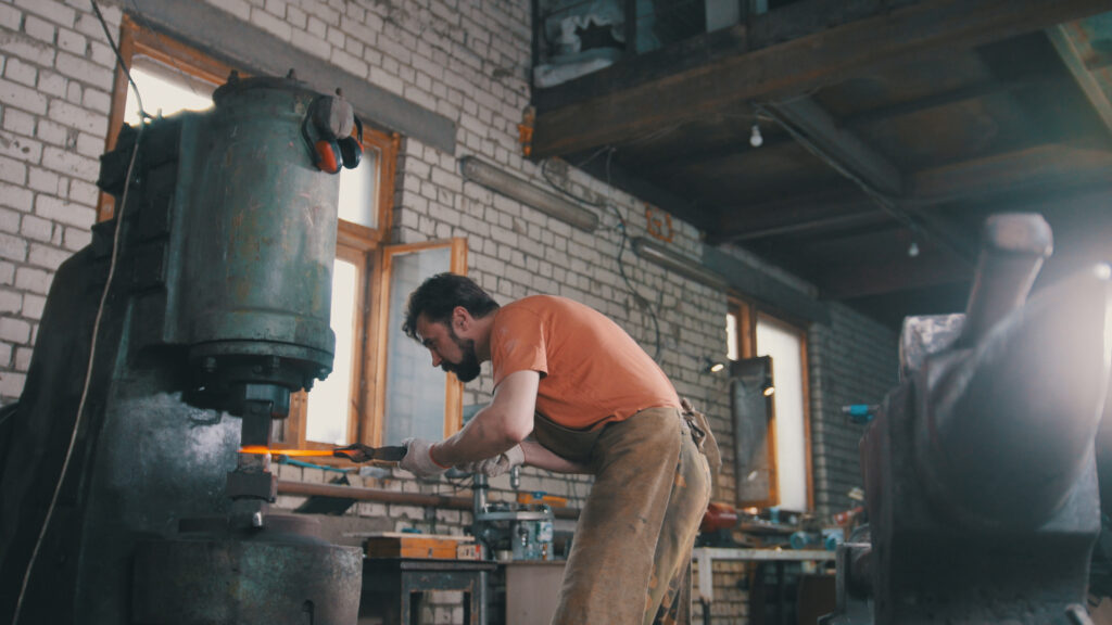 blacksmith forging a knife