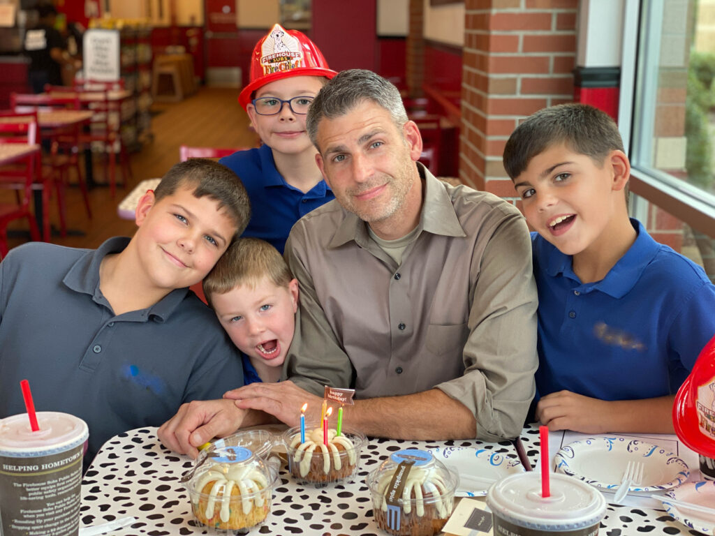 the author's husband and sons at FIrehouse Subs enjoying Nothing Bundt Cakes